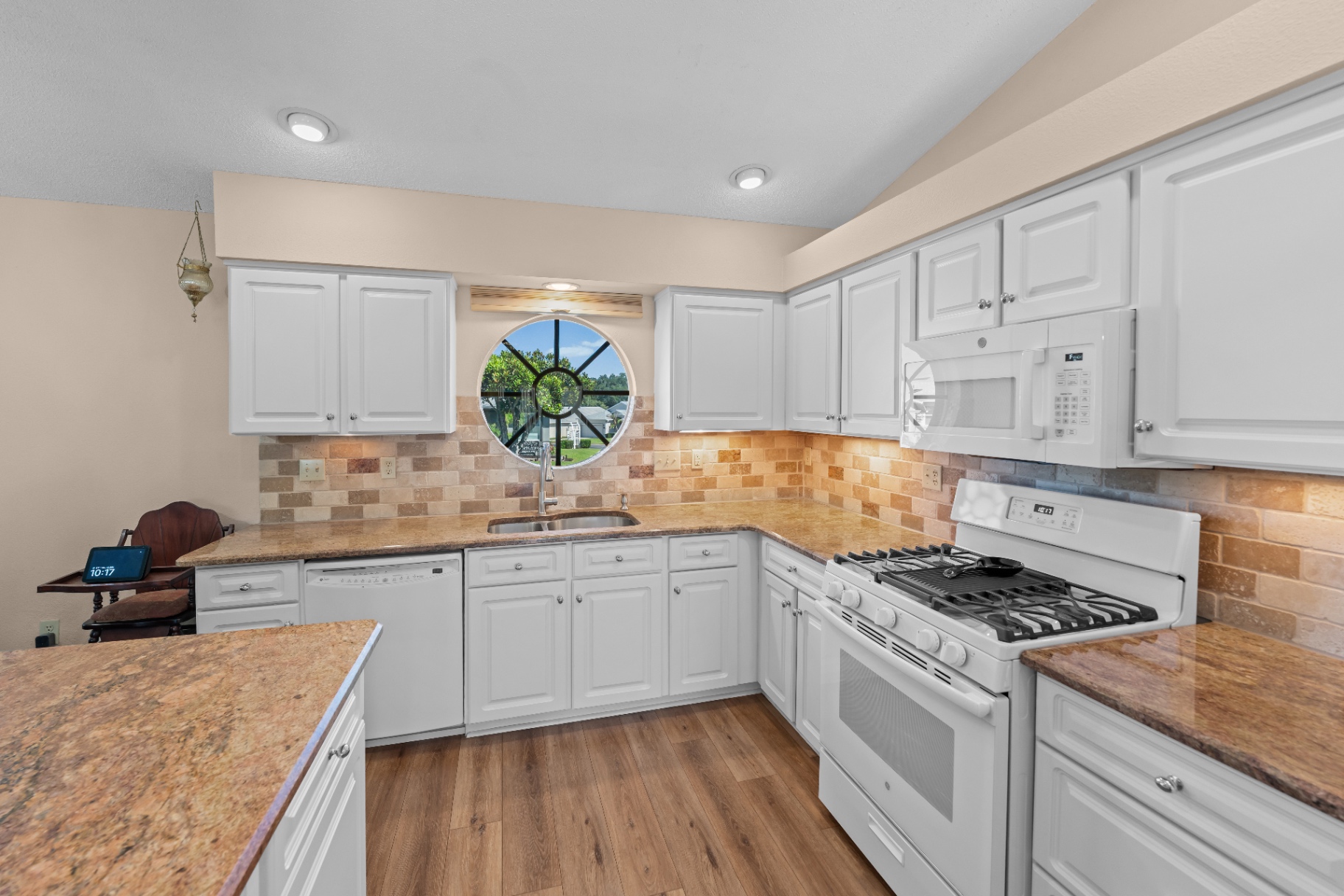 Kitchen with round feature window over the sink