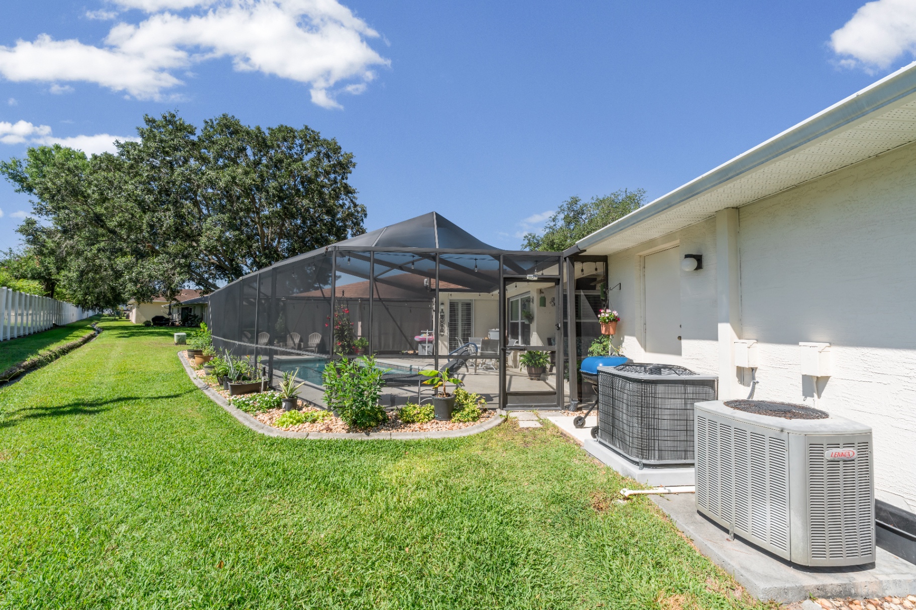 Backyard side yard and screened enclosure