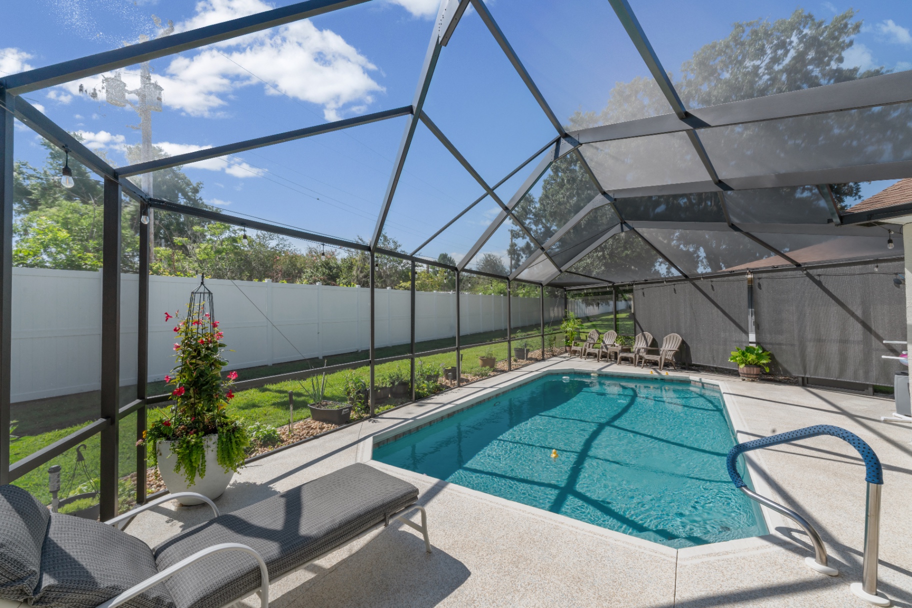 Screened pool with lounge chairs